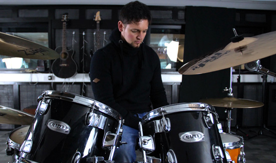A young man at a drum kit