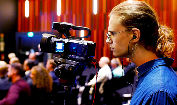 David Blomquist filming in a busy event